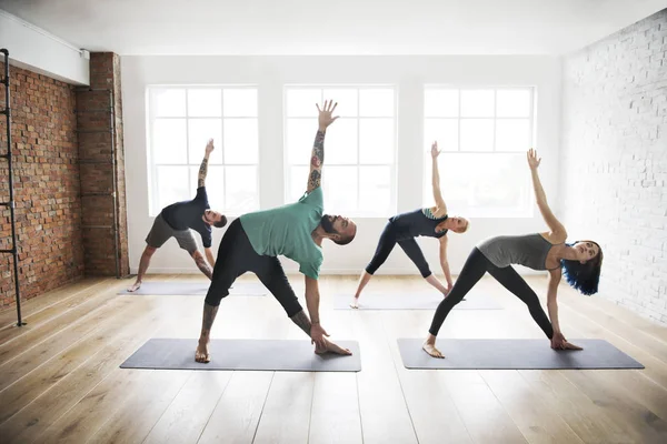 people doing yoga practice in class