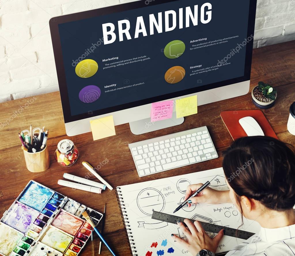 Woman drawing in sketch-book, computer on desk,  Branding Concept