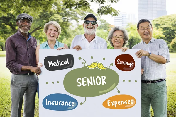 Senior people with blank at park — Stock Photo, Image