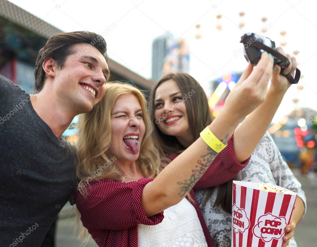friends making selfie in Amusement Park