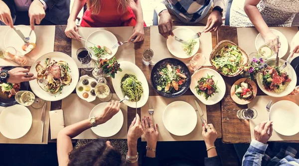 Teman-teman ceria makan di restoran — Stok Foto