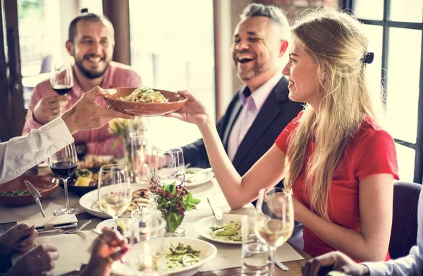 cheerful friends eating in restaurant