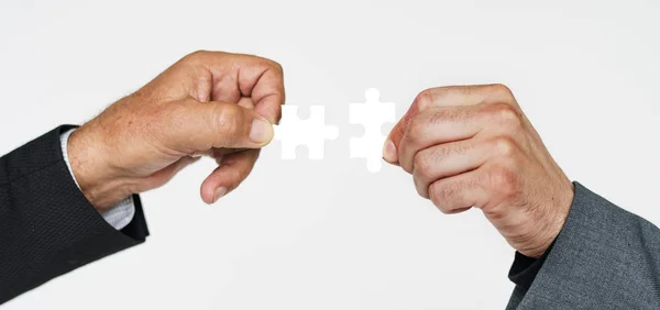 Business people's hands holding puzzles — Stock Photo, Image