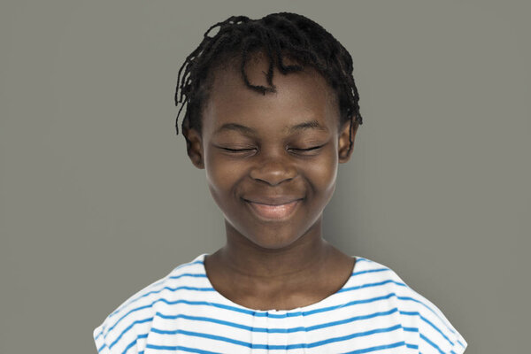 African little girl smiling with closed eyes and standing at background in studio, portrait concept, original photoset