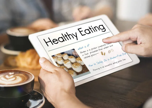 Person using tablet in coffee shop — Stock Photo, Image