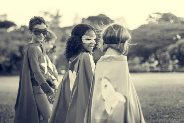 Children in superhero costumes in the park — Stock Photo, Image
