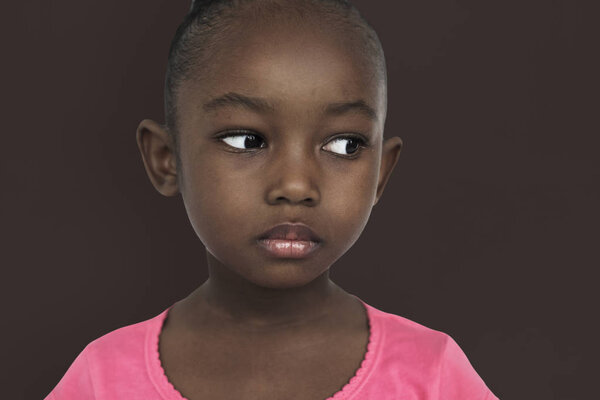 Little african Girl posing in studio, emotion serious Concept