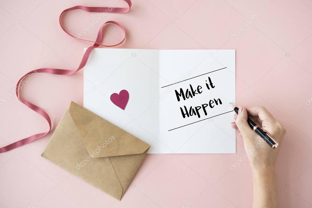 human hands writing on greeting card