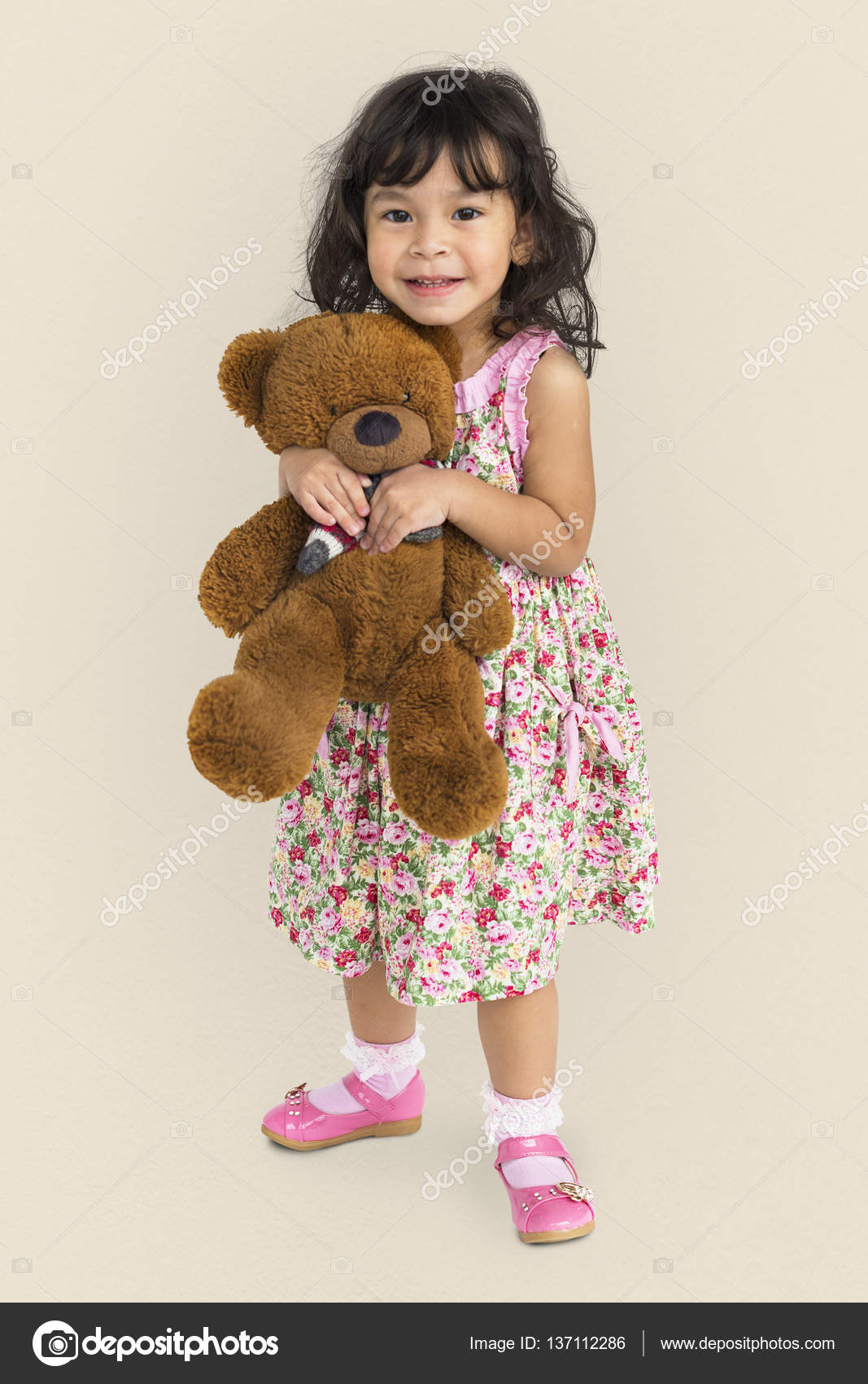 little girl holding a teddy bear