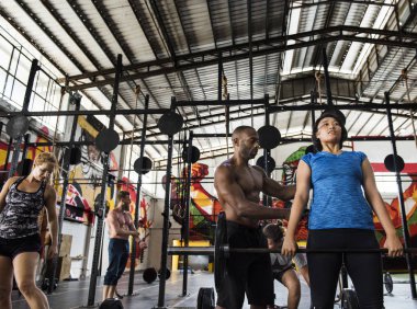 Spor salonunda egzersiz yapan insanlar