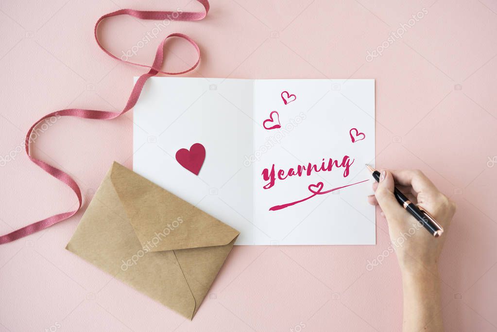 human hands writing on greeting card