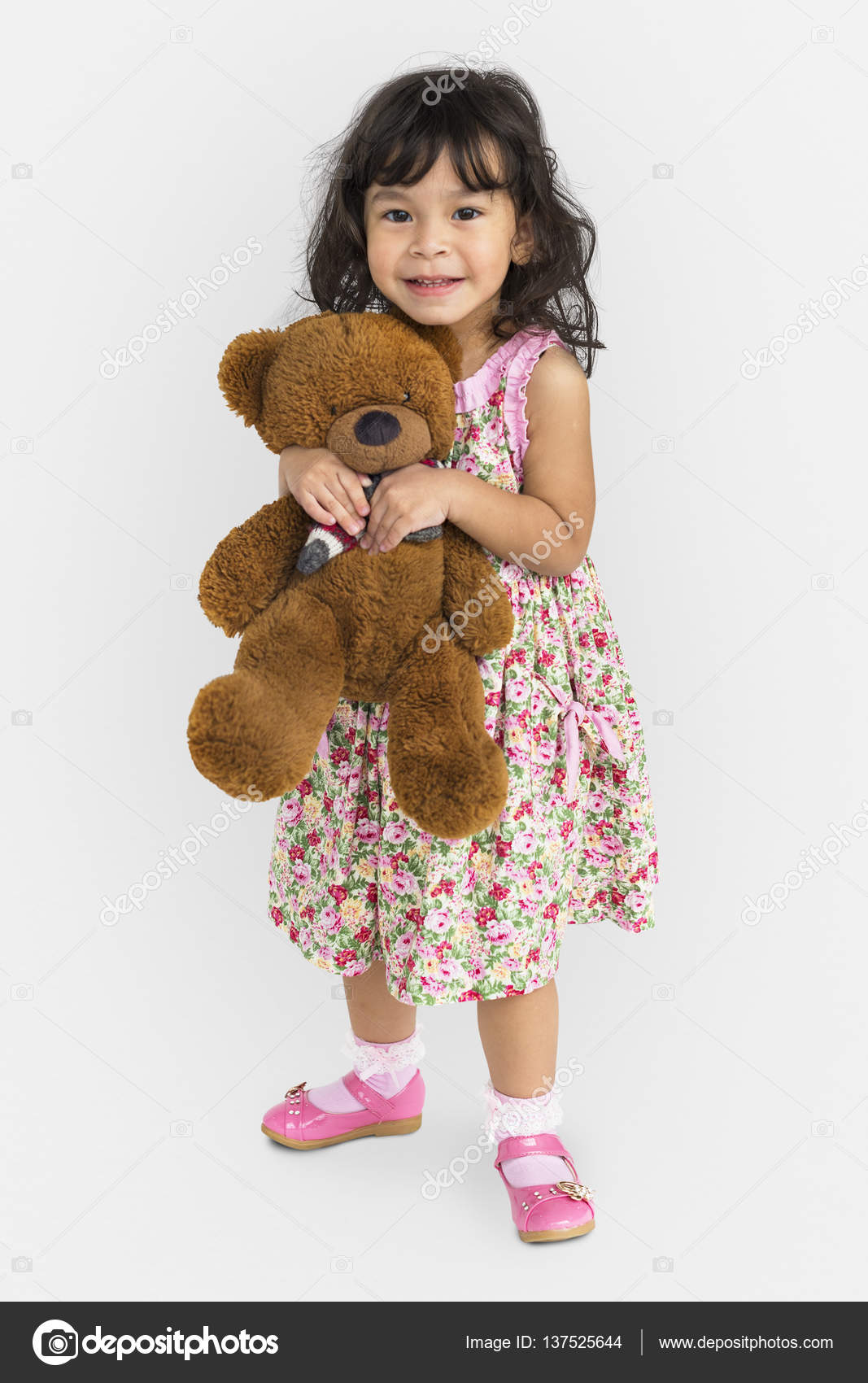 girl holding a teddy bear