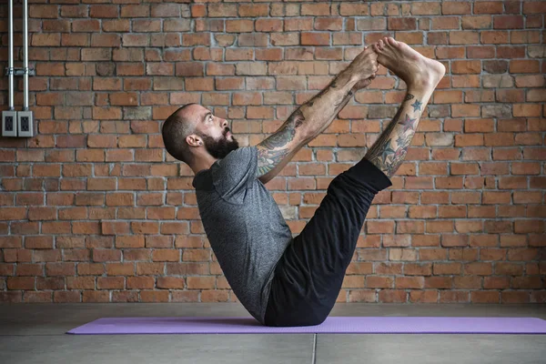 Man doing yoga workout exercise — Stock Photo, Image