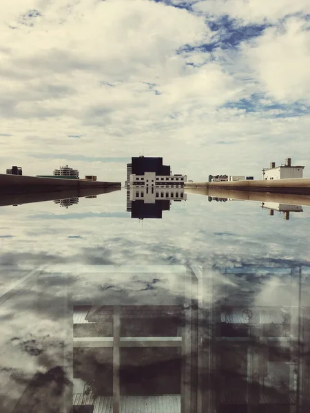 Reflection of the Building in the puddle — Stock Photo, Image
