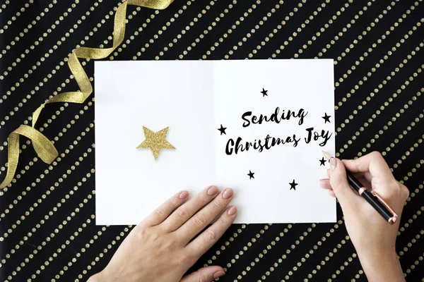 Person writing on greeting card — Stock Photo, Image