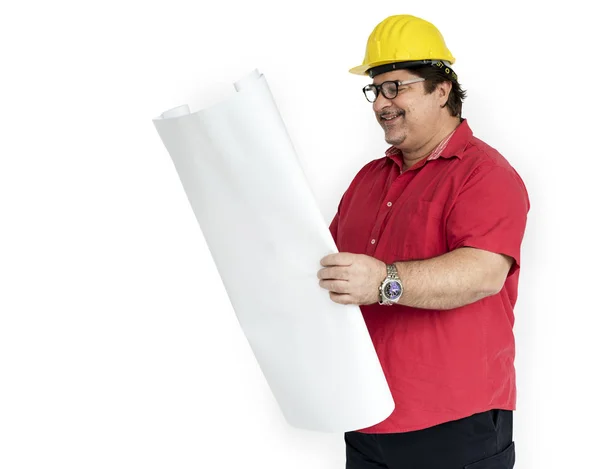 Man in yellow helmet holding blueprint — Stock Photo, Image