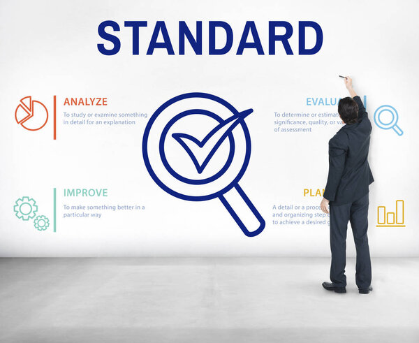 Бизнесмен в костюме стоит у стены
