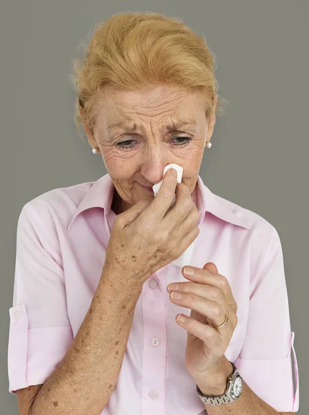 Senior Kvinna blåser näsan — Stockfoto