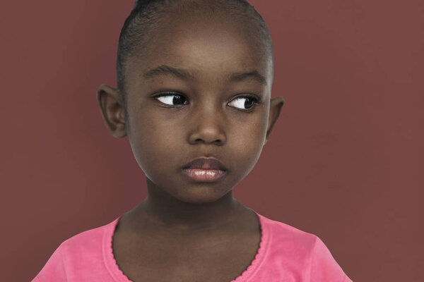 Serious african little girl posing in studio, portrait and face concept, original photoset