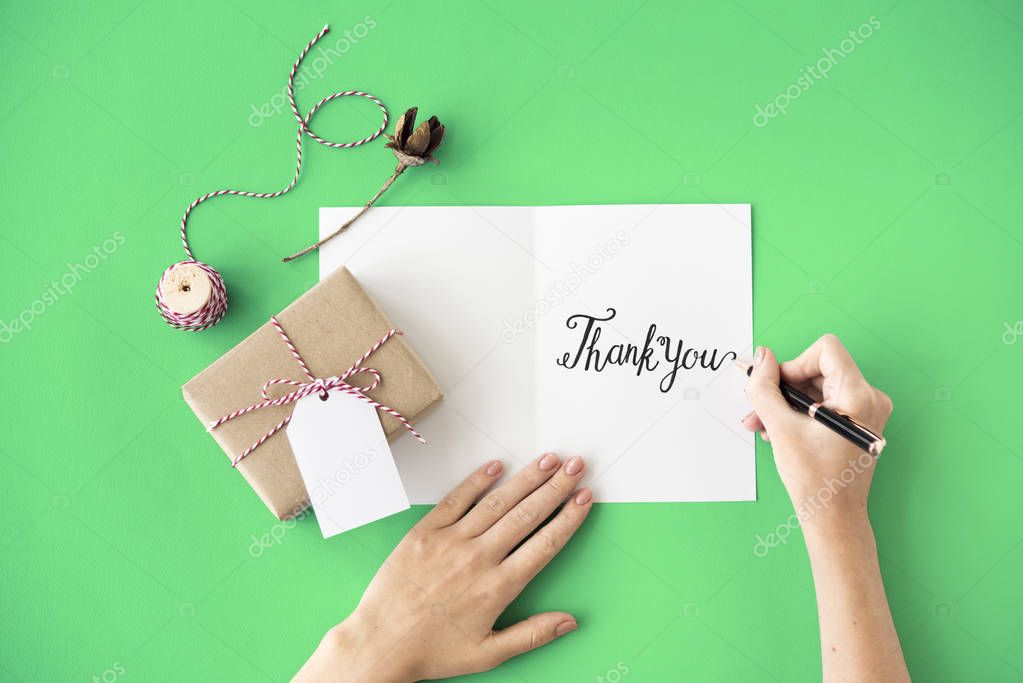 person writing on greeting card