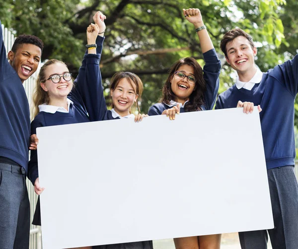 Students holding white board — Stock Photo, Image