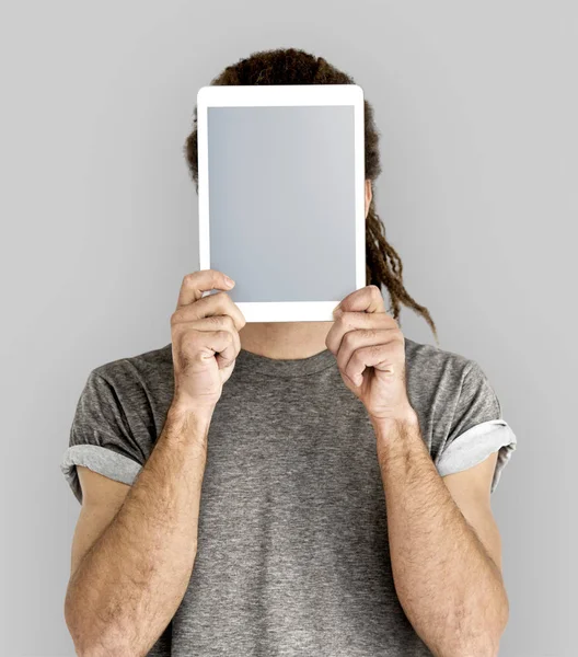 man Covering Face with Digital Tablet.