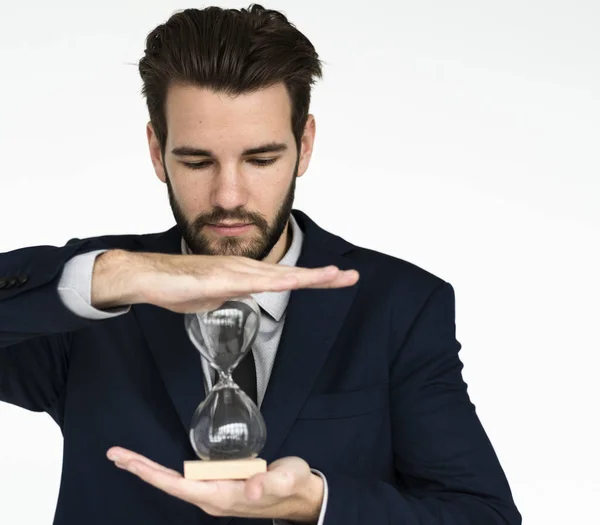Businessman holding hourglass — Stock Photo, Image