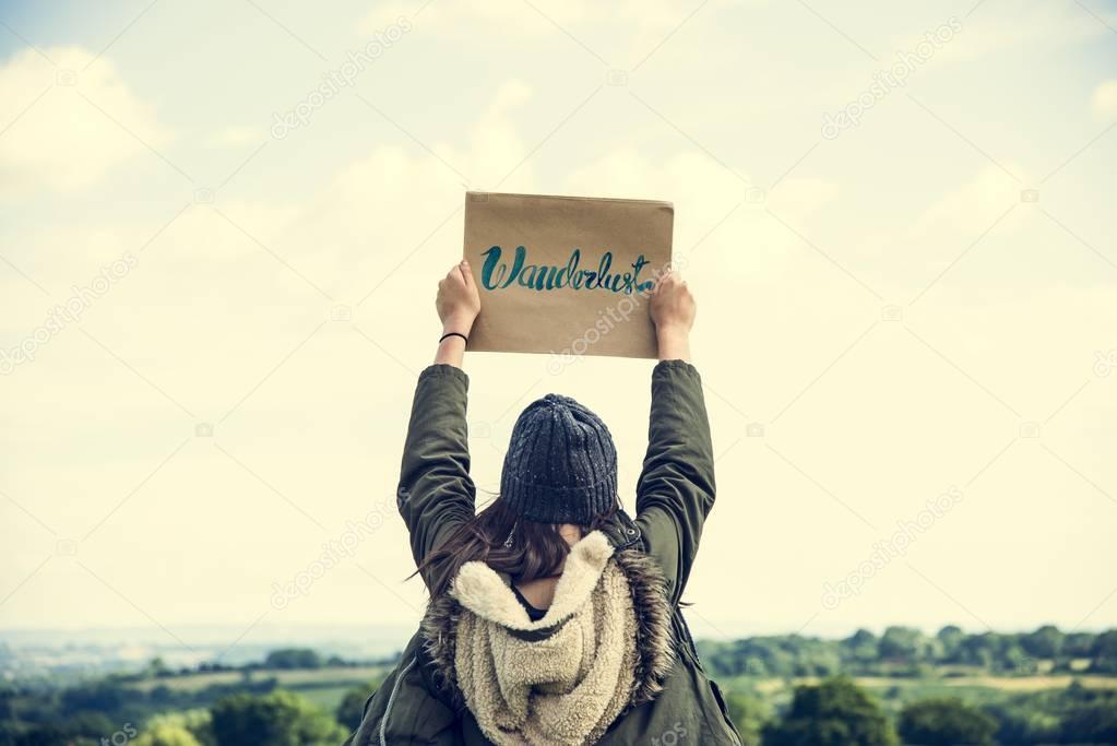 Woman holding paper outdoors