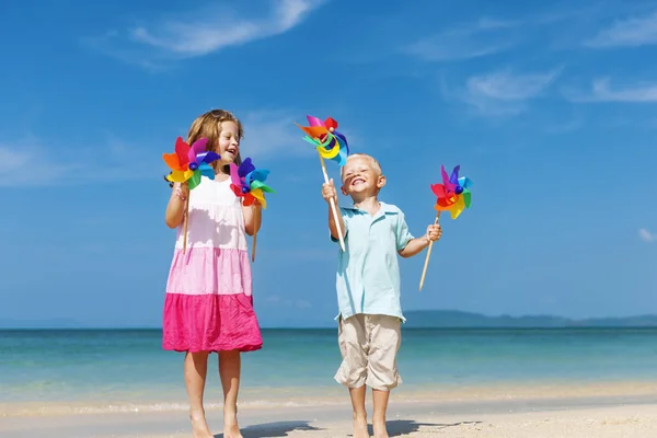 Children playing with wind flowers — Stock Photo, Image