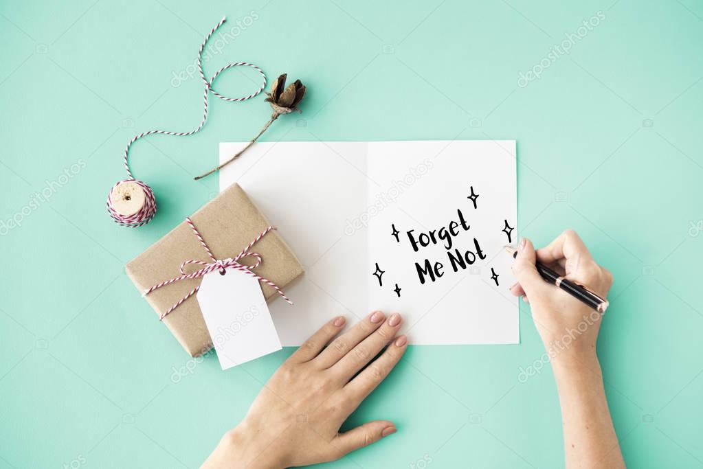 person writing on greeting card