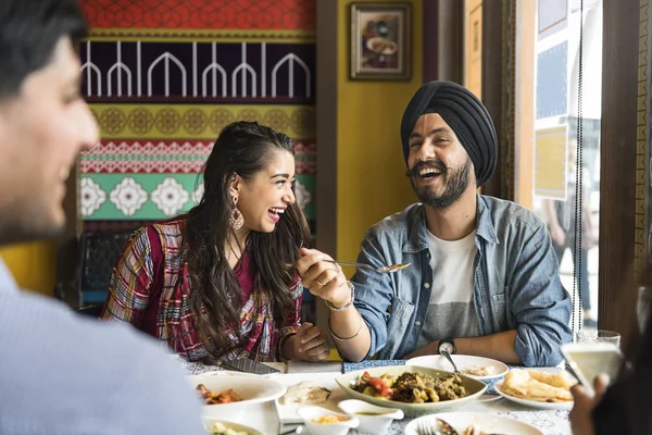 people eating Indian Food in restaurant
