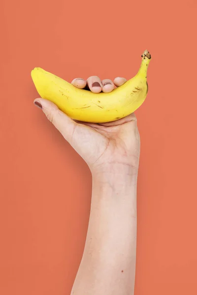 Human hand holding banana — Stock Photo, Image