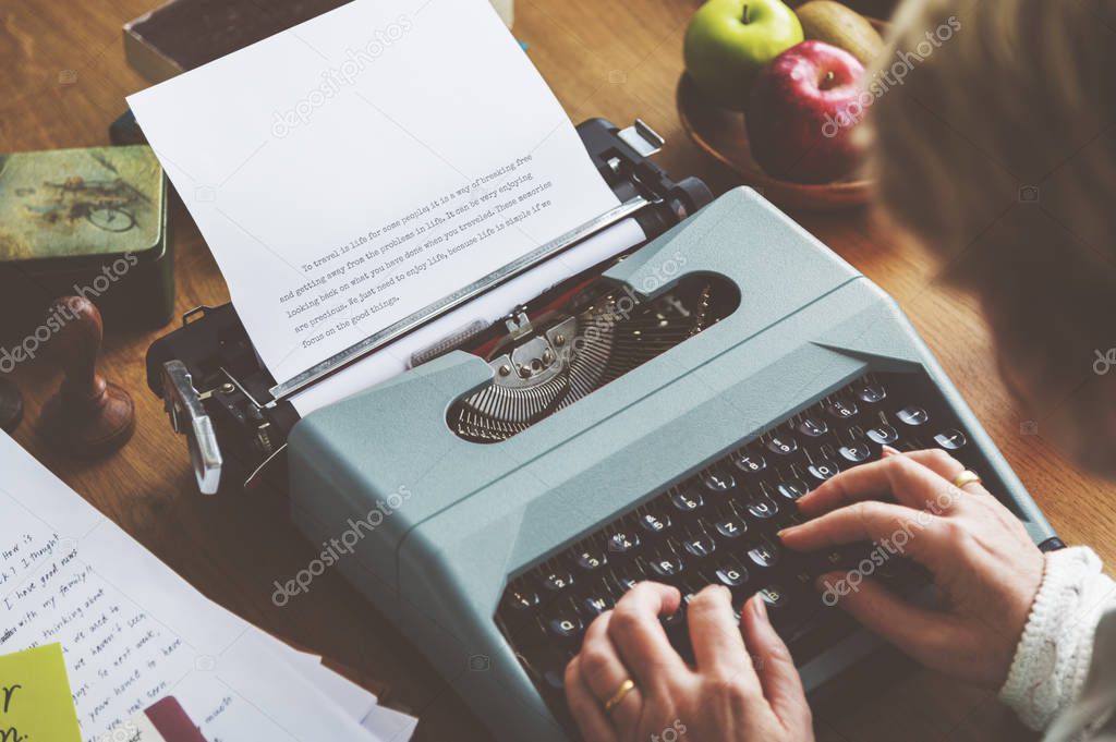 woman typing on vintage typewriter machine