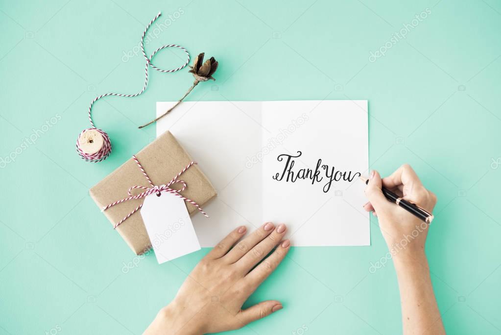 person writing on greeting card