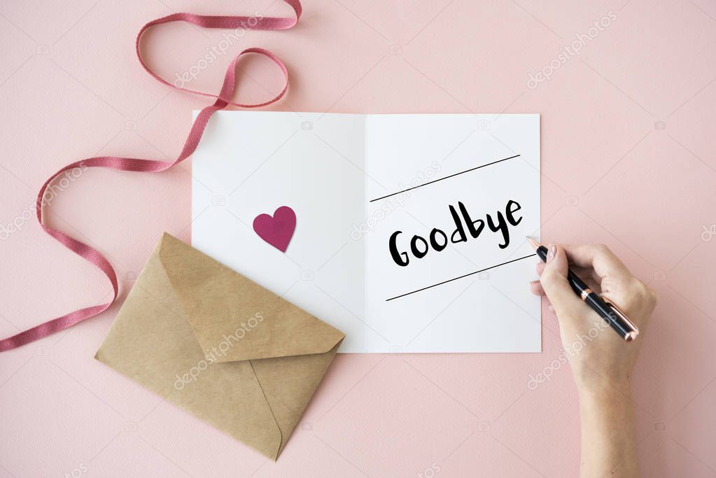 human hands writing on greeting card