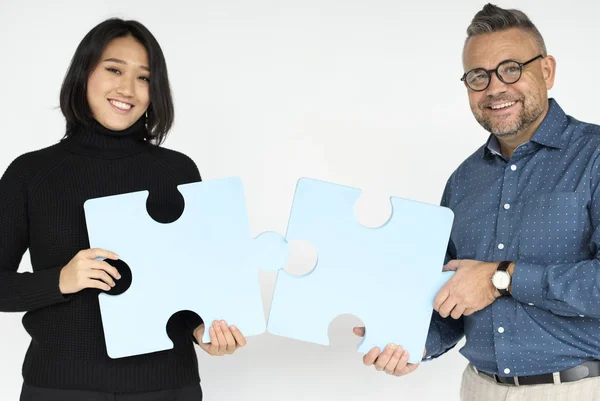 people holding puzzle pieces