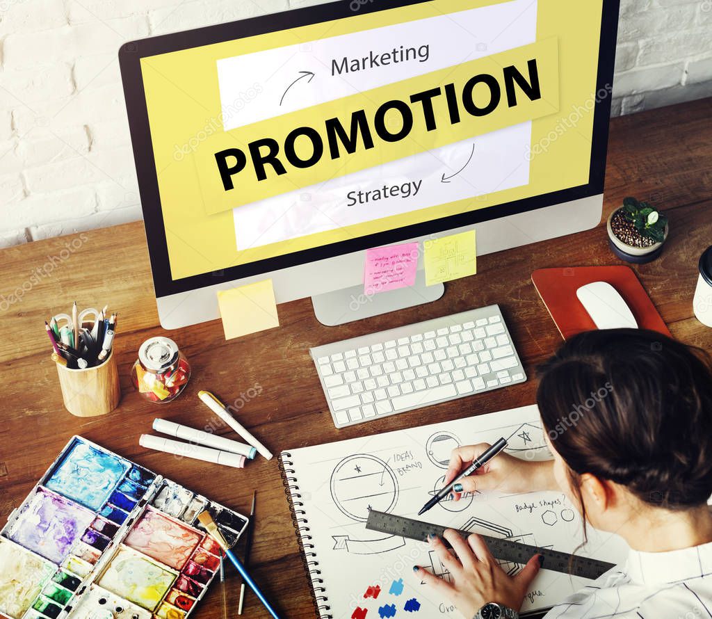 Woman working in art studio, workplace table with colorful paint, art tools, keyboard, graphic designer concept, monitor screen with text: Promotion