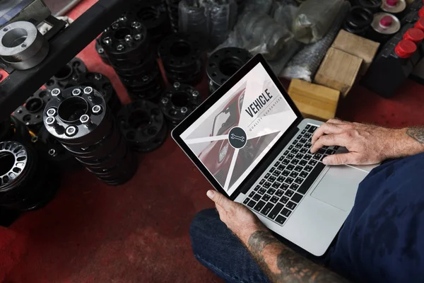 Meccanico di auto utilizzando laptop in garage — Foto Stock