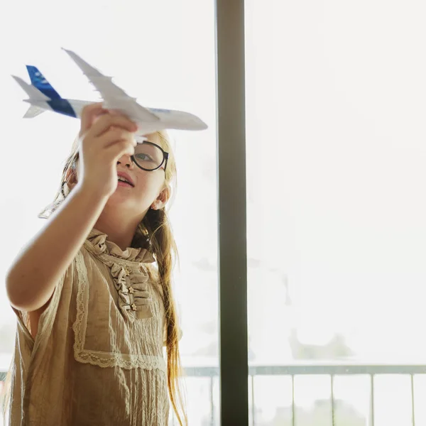Girl playing with toy airplane — Stock Photo, Image