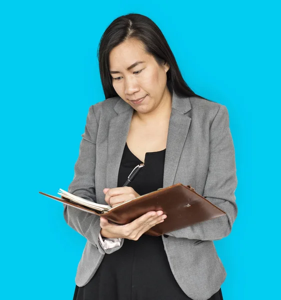 Businesswoman writing in notebook — Stock Photo, Image