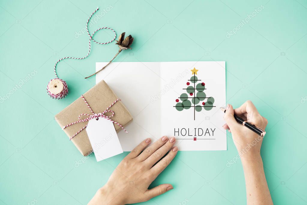 person writing on greeting card