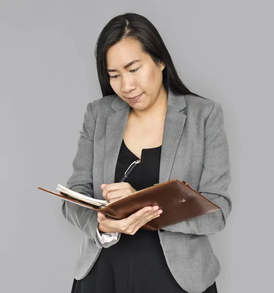 Businesswoman writing in notebook — Stock Photo, Image