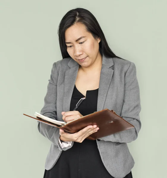 Businesswoman writing in notebook — Stock Photo, Image