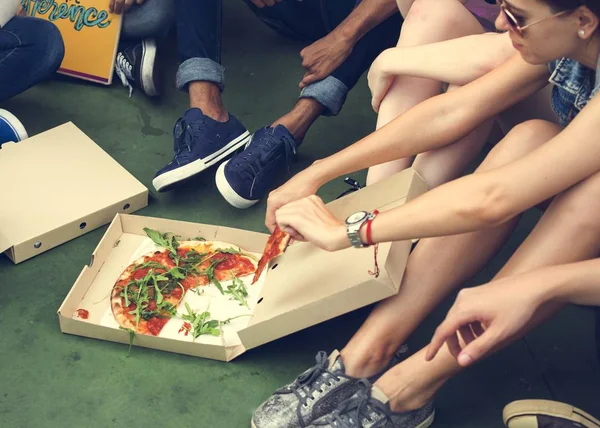 Φίλοι κάθονται στο πάτωμα και να τρώει Πίτσα — Φωτογραφία Αρχείου