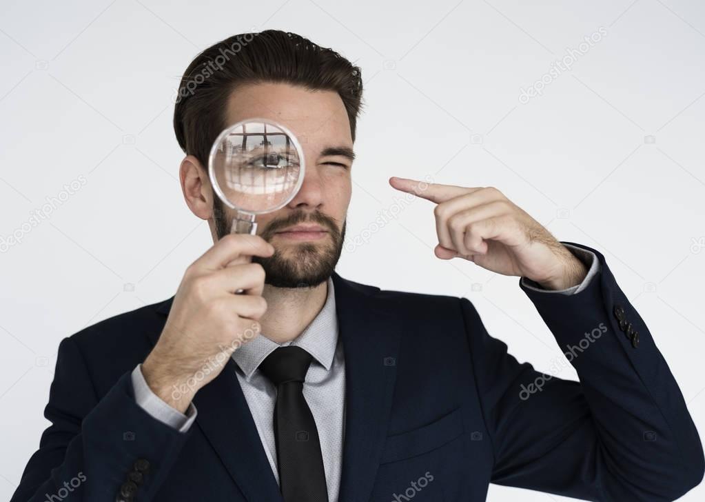 businessman looking at magnifying glass