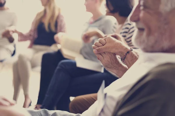 People in counseling holding hands — Stock Photo, Image