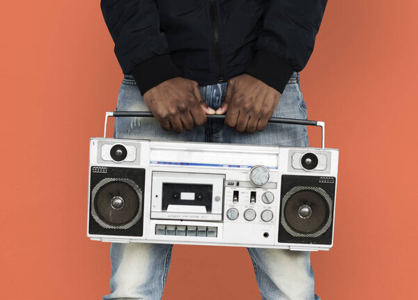 African man listening music in boombox