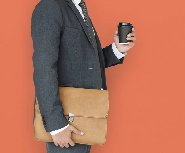Empresario sosteniendo café y bolsa —  Fotos de Stock