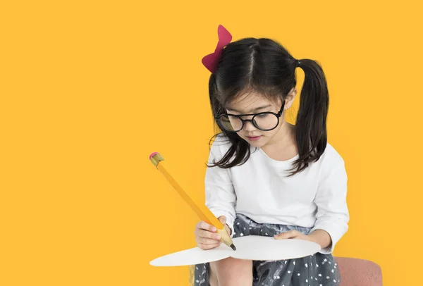 Girl writing with big pencil — Stock Photo, Image