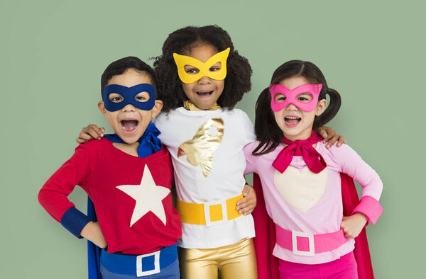 children wearing superhero costumes